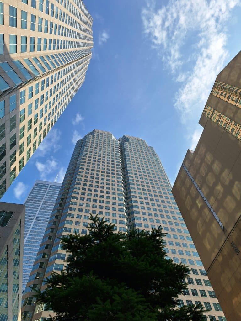 all glass and steel skyscrapers in downtown Los Angeles viewed from the ground, representing LA’s business and digital presence.
